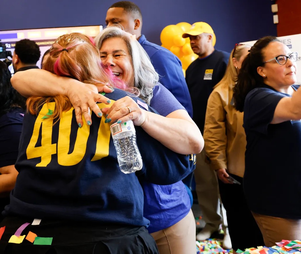 Nonprofit leaders embracing at an Alliance event