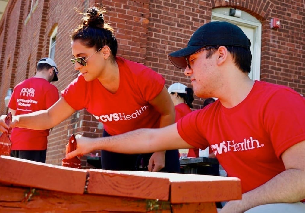 Corporate volunteers building a community structure